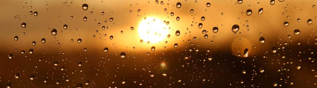golden sunset through a window with rain