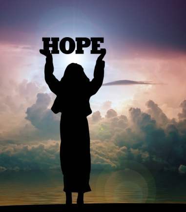 woman holding sign that says hope