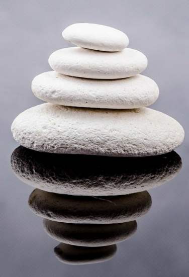 stack of white stones reflecting in water